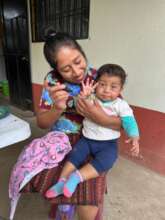 A mom sharing a nutritious meal with her infant
