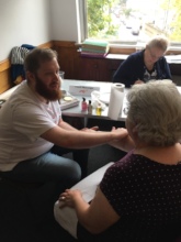 A new Time Bank member enjoys a hand massage