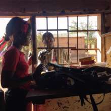 Vero at her shop with a customer