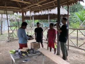 Beekeepers demonstrate hive construction on camera