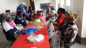 Jitegemee mothers learning basket-weaving.