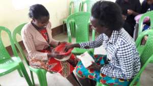 A mother teaches one of our students her new skill