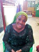 Aidah smiling as she waits for her check up