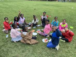 Congolese girls enjoy their pizza after soccer