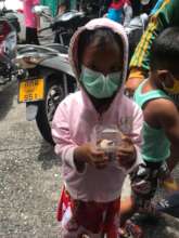 Child receiving food aid from Tamar Center