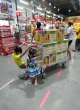 Our kids helping us shopping for food donations