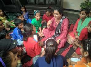 Chairperson Meera with the children of the project