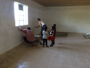 Volunteers kendra and Josh painting the boarding h