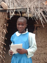 Student is front of school latrine targeted for replacement