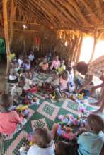 Youngest Students with Foam Blocks on Dirt Floor