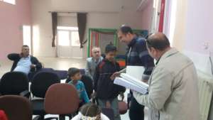 Children receiving a braille book gift