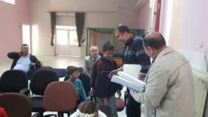 Children receiving a braille book gift