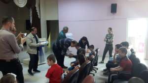 Children receiving braille book gift