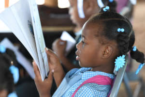 A student reads a mother tongue book at school.