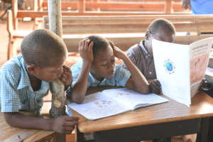 Students reading books in Haitian Creole.