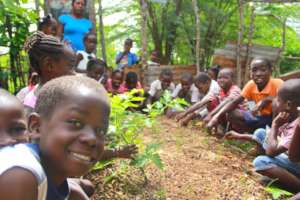 Students and their teacher in a school garden.