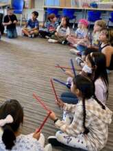 Learning to Play Together with Rhythm Sticks