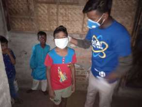 Think Tank member affixes a mask