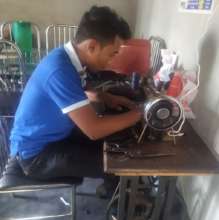 Think Tank member sewing a mask