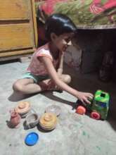 Suma playing with toys at home