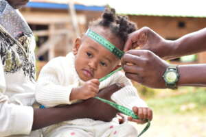 A Health officer conducting growth monitoring