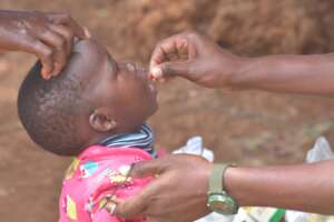 A community Health officer deworming a child.