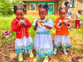 Children eating RUSF during nutrition outreach