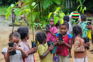 Kids at Club Atsatsaky planting fruit trees