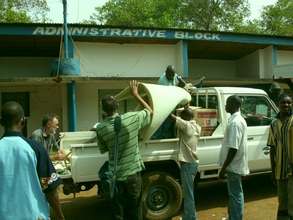 Students unloading the solar hot water materials