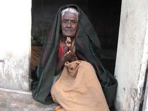 Poor Aged woman with winter clothes