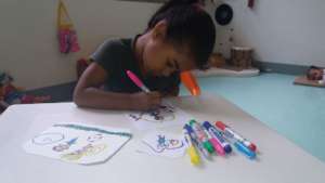 Anyely, 4, drawing at the Centro Llanaditas