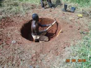 Skilled worker hand digging 25 meter deep well