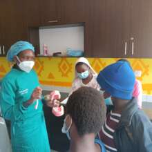 Dentist explaining oral hygiene to the students