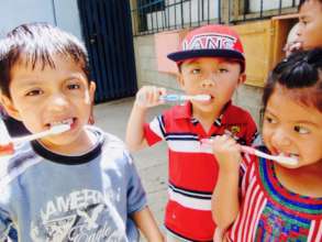 Brushing our teeth with homemade toothpaste!