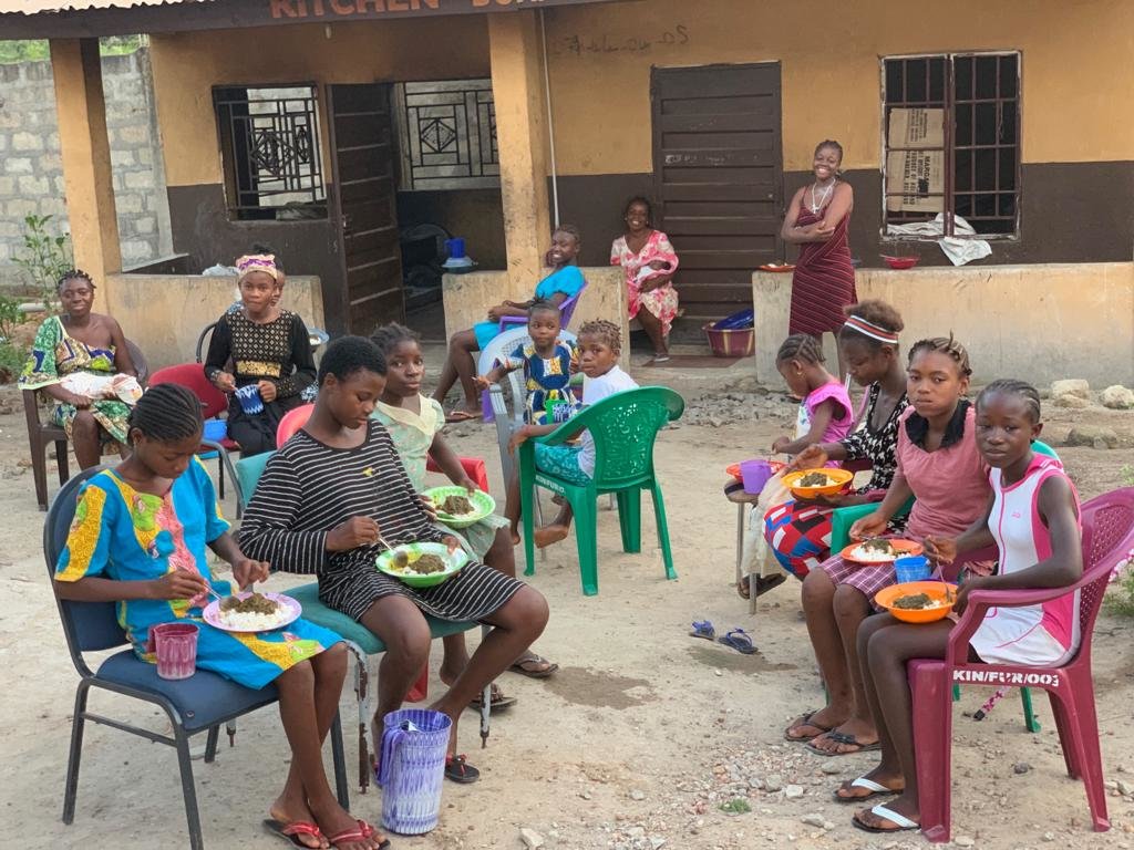 Kids eating at shelter.