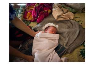 A newborn baby in a cloth wrap