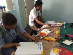 Teenagers during a painting class