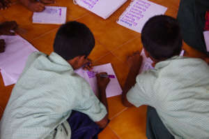 Girls study after school in one of the homes