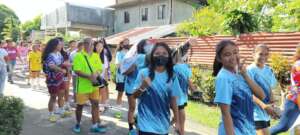 Girl players participate in community parade.