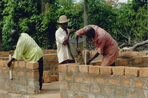 Friends of the future houseowner help to construct the house