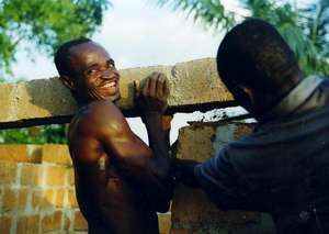 Fidelis Nwandugu helps to mount an overlayer