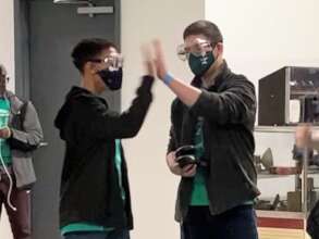 Team members high-fiving at an event