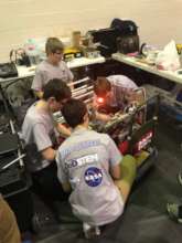 Teams troubleshoot and make repairs in the pits.