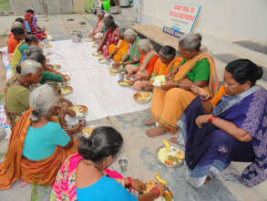 poor elderly persons are having food at daycare