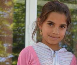 8-year-old girl Isa* in the yard