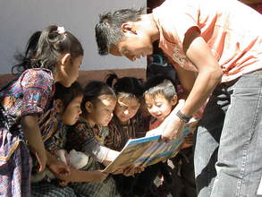Juan Carlos reading to children in his community