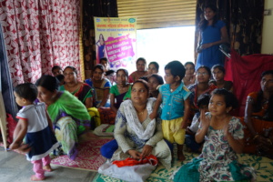 A group of women gathering for the sewing training