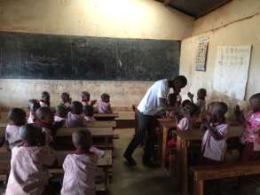 Primary 1 at Gasabo school w/ their teacher Claude