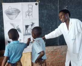 Josephine using one of the NOEC wall charts