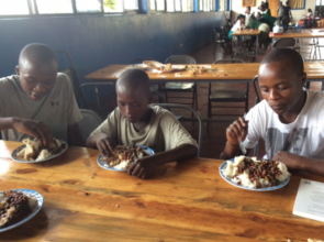 Kayitare's first meal at school (in white shirt)